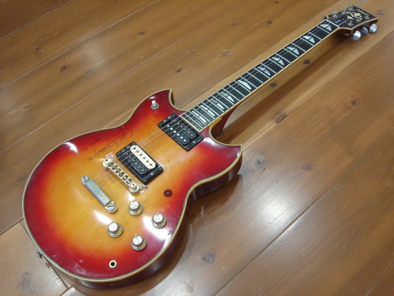 Full front view of the red sunburst Yamaha SG1000