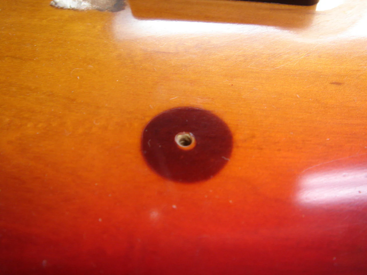 Rubber residue left by the removed pickguard