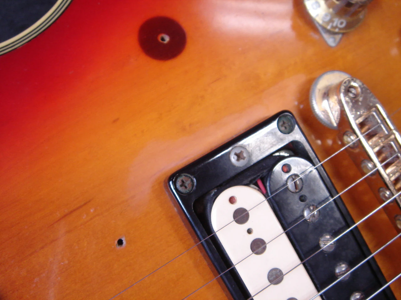 Worn white area beside the bridge pickup ring