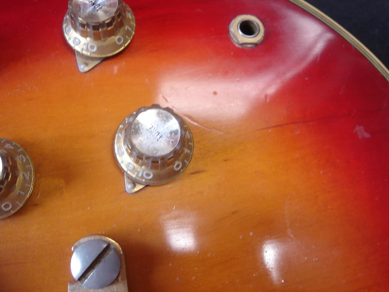 Arc-shaped Orange Squeezer scratches near the output jack