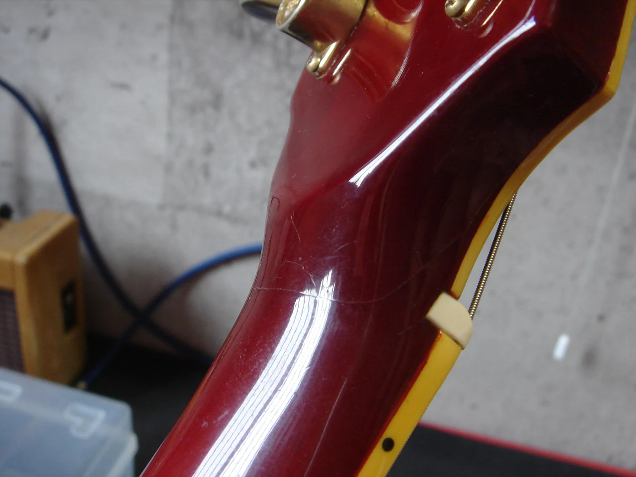 Repaired crack at the guitar's headstock joint