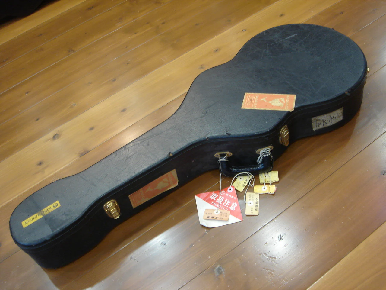 Original black guitar case with airline tags