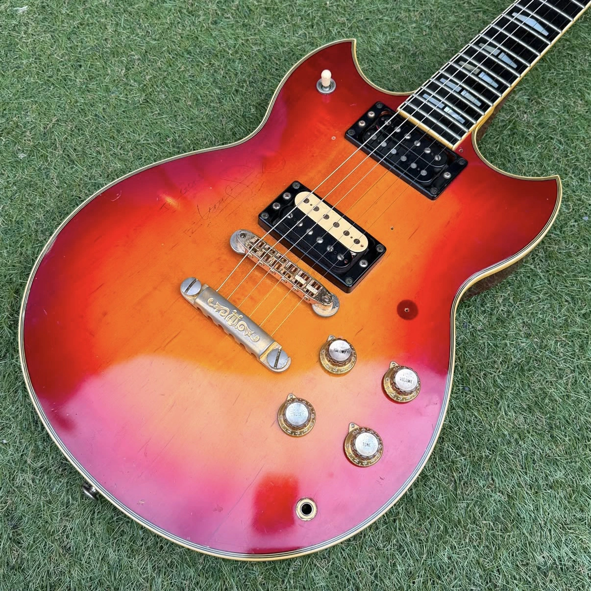 Takanaka's red sunburst 1976 Yamaha SG1000 on grass